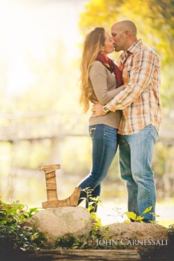 engagement photos of couple hugging outdoors in warm golden light, natural candid couple portrait