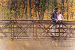engagement photo of couple on a wooden bridge in autumn in Upstate NY