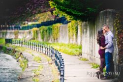 engagement photo of curved walkway with railing, urban engagement location backdrop