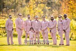 Wedding party photo outdoors with men in pink suits