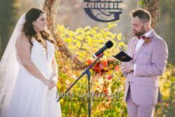 Bride and groom exchanging vows outdoors.