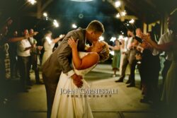 Bride and groom kissing during a sparkler exit
