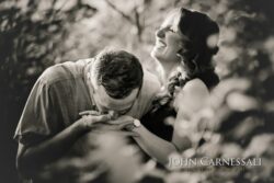 black and white engagement photo of couple lying close together, romantic documentary couples portrait