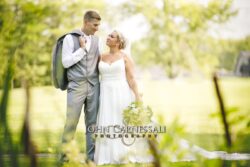 Bride and groom standing together with bouquet