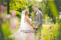 Bride and groom standing together outdoors