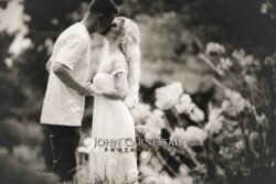 black and white engagement photo of couple kissing, documentary style couples portrait