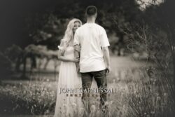 black and white engagement photo of couple from behind walking together, documentary couple portrait