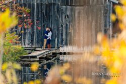 engagement photo of couple on a walkway with reflections in water