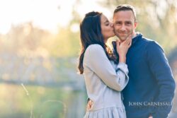 Engagement photo of couple close together in soft golden backlight, romantic engagement portrait