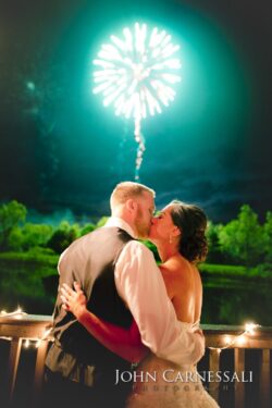 Couple kissing under fireworks at night.