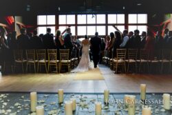 Bride escorted down candlelit aisle