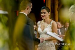 Bride smiling during wedding vows
