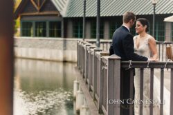 Bride and groom on wooden railing