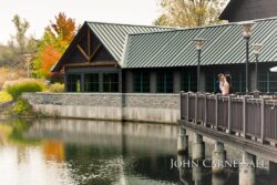 Couple standing on lakeside deck