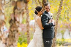 Couple embracing in wooded fingerlakes wedding venue