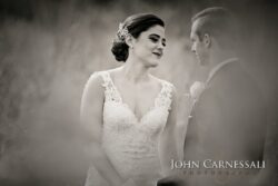 Bride and groom in wedding attire, outdoors.