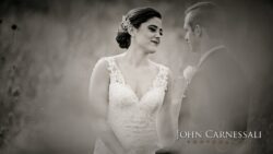Bride and groom in romantic black-and-white portrait.