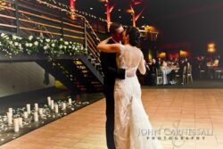 Couple kissing beside candlelit staircase