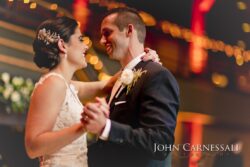 Smiling couple dancing with warm bokeh lights
