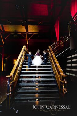 Children descending decorated staircase at event.