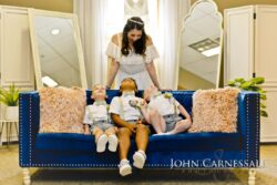 Bride and children seated on blue couch.