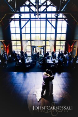 Couple dancing in elegant, spacious venue.