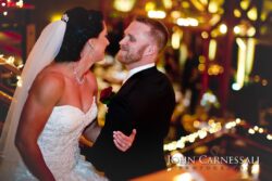 Bride and groom smiling in wedding attire.
