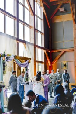 Indoor wedding ceremony with officiant and guests.
