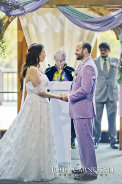 Bride in lace gown, groom in lavender suit