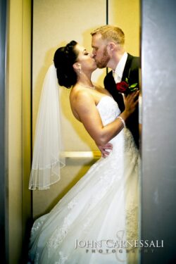 Newlyweds kissing inside elevator