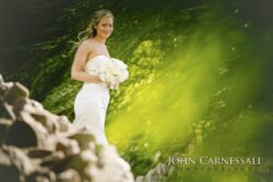 Smiling bride in strapless gown with bouquet