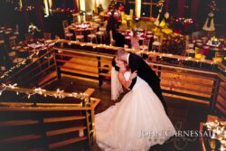 Bride and groom kissing on decorated staircase