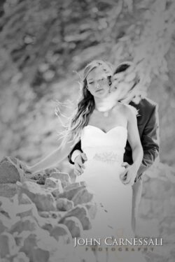 Black and white bride hugged by groom