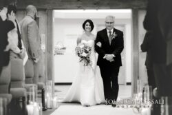 Bride walking down aisle with escort.