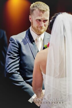 Groom and bride exchanging vows at wedding.