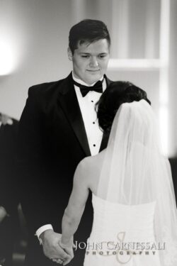 Bride and groom holding hands at wedding.
