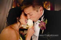 Bride and groom sharing ice cream cone.