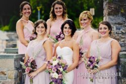 Bridal party with bouquets, outdoor setting.