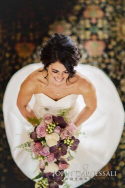 Bride holding bouquet, photographed from above.