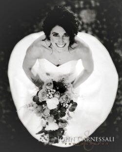 Bride smiling with a bouquet of flowers.