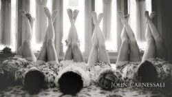 Women lying with legs raised, wearing robes.