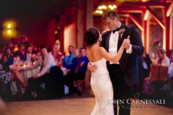 Bride and groom slow dancing on ballroom floor