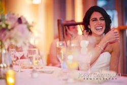 Laughing woman at a wedding reception table.