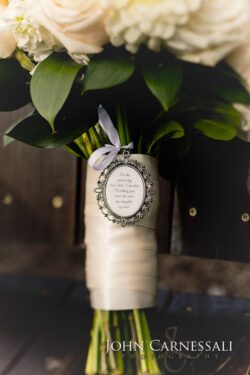 Bridal bouquet with decorative photo charm.