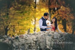 Family portrait outdoors with autumn leaves