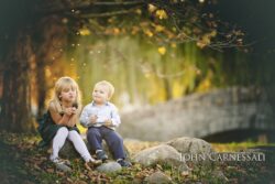 Mother sitting outdoors with two young children