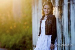 Young girl standing in warm sunlight