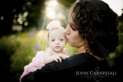 Mother holding her baby close outdoors
