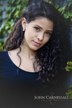 Portrait of a teenage girl with curly hair outdoors
