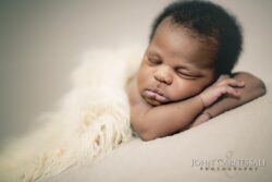 Close-up of a sleeping newborn on a soft blanket
